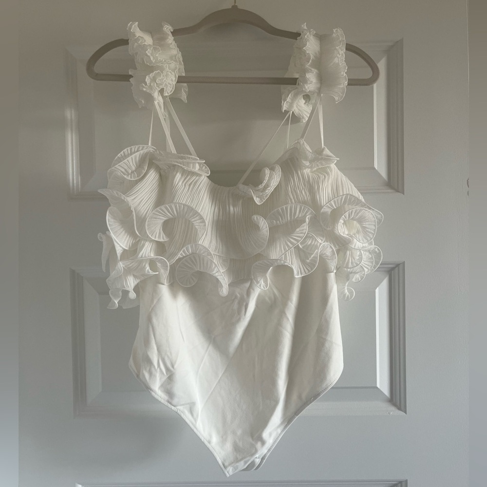 NWT white ruffle size large free people bodysuit. Never worn